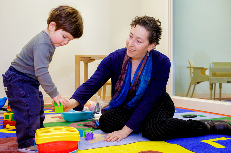 Diana Robins, PhD, of the A.J. Drexel Autism Institute, plays with a toddler who is in the age range that she believes all children should be screened for autism spectrum disorder. Photo by Jeff Fusco.