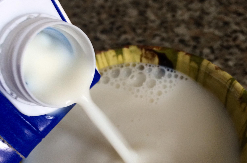 Milk being poured into a bowl.