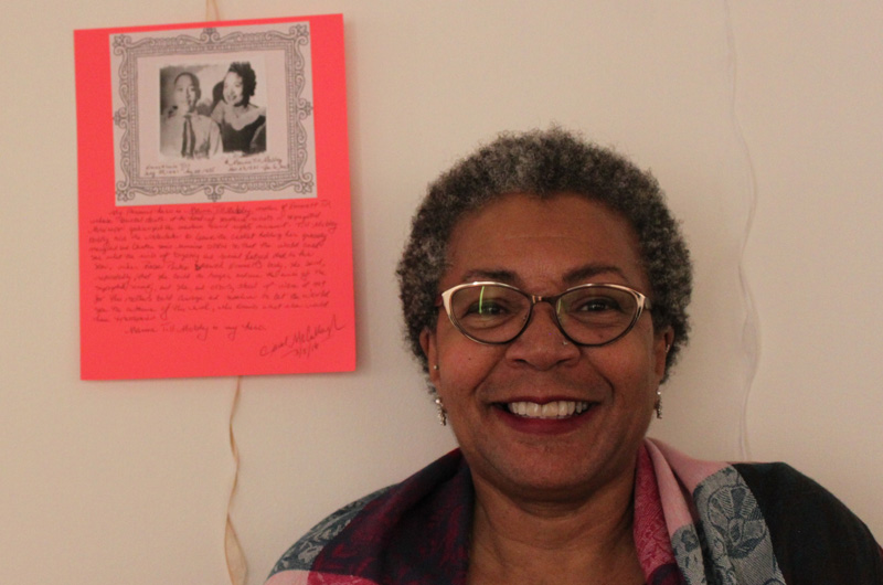 Carol Richardson McCullough standing with a piece she wrote as a part of Writers Room. Courtesy of Rachel Wenrick.