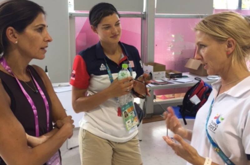 Fiona Pelly, PhD, director of nutrition of the World University Games is discussing food quality with Drexel's Nyree Dardarian and Coco Ellis.