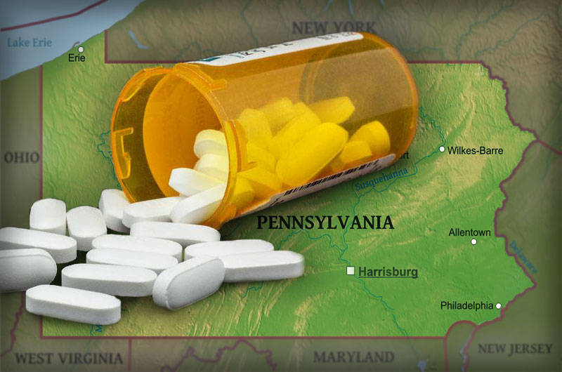 A bottle of pills overturned over a map of Pennsylvania.