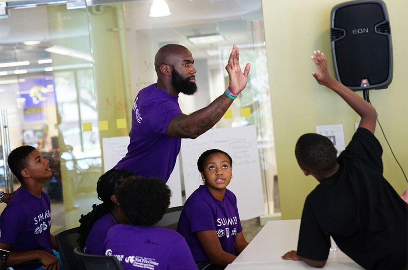 Malcom Jenkins interacting with students at Young Dragons camp in 2016.