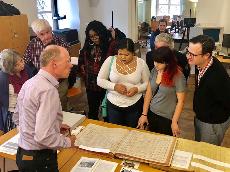 The Drexel delegation visiting the Dornbirn archives and examining records on Francis Martin Drexel. 