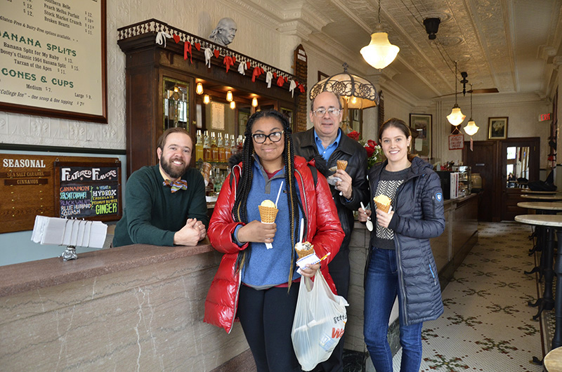 Franklin Fountain co-owner Eric Berley, left, with Drexel student Toni Hicks, assistant clinical professor Michael H. Tunick and student Nora Vaughan at the local ice cream parlor Franklin Fountain in February 2019. Vaughan and Hicks were finalists in a Drexel ice cream contest partially judged by Berley and Tunick in which the winner designed an ice cream sold at Franklin Fountain.