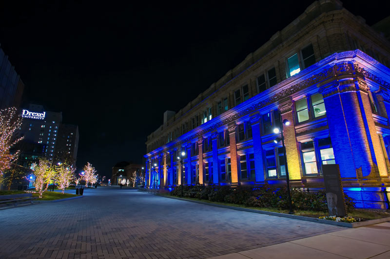 Main Building lit up in blue and gold for Drexel's virtual celebration for the Class of 2020. 