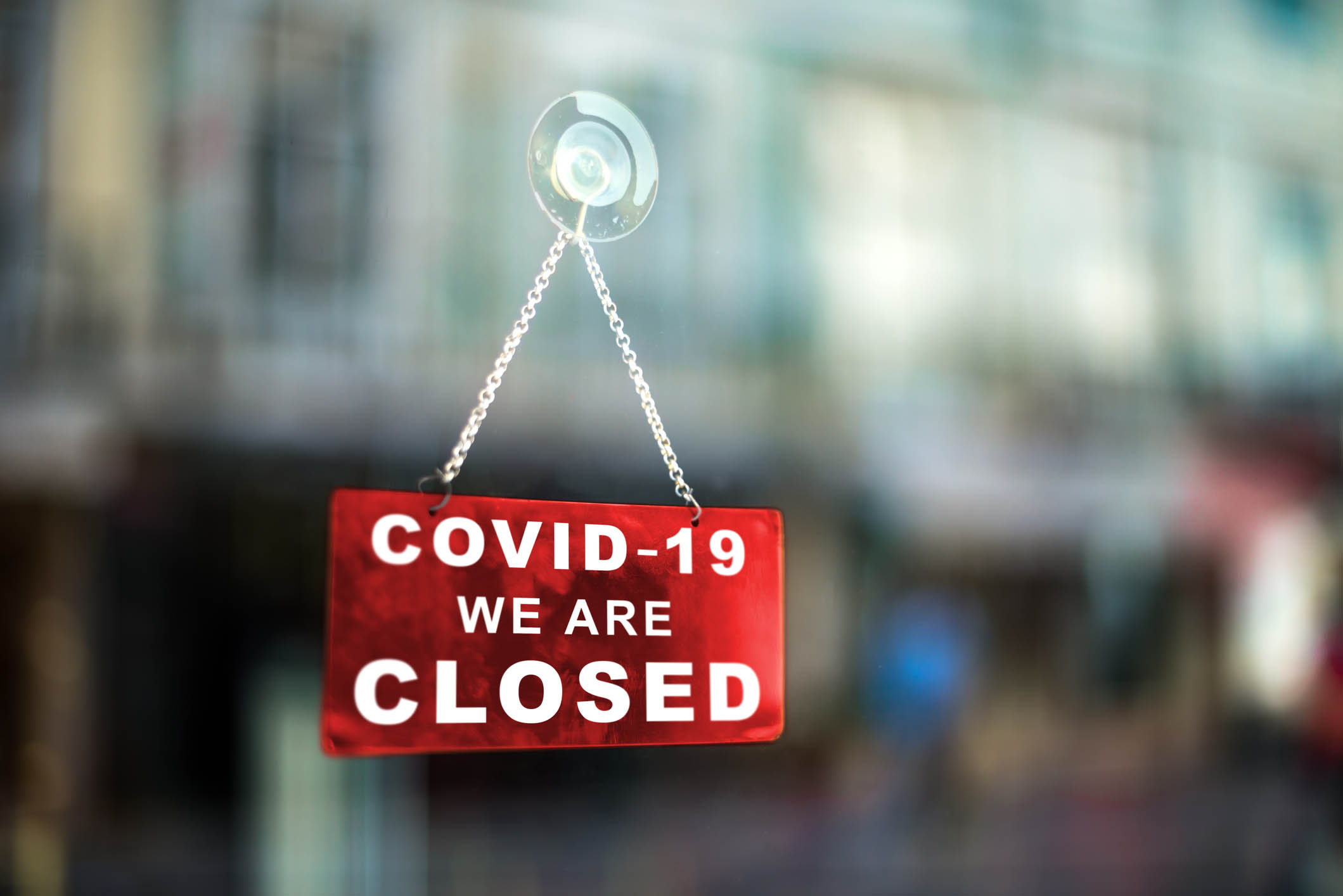 sign on a retail store that says its closed due to COVID-19