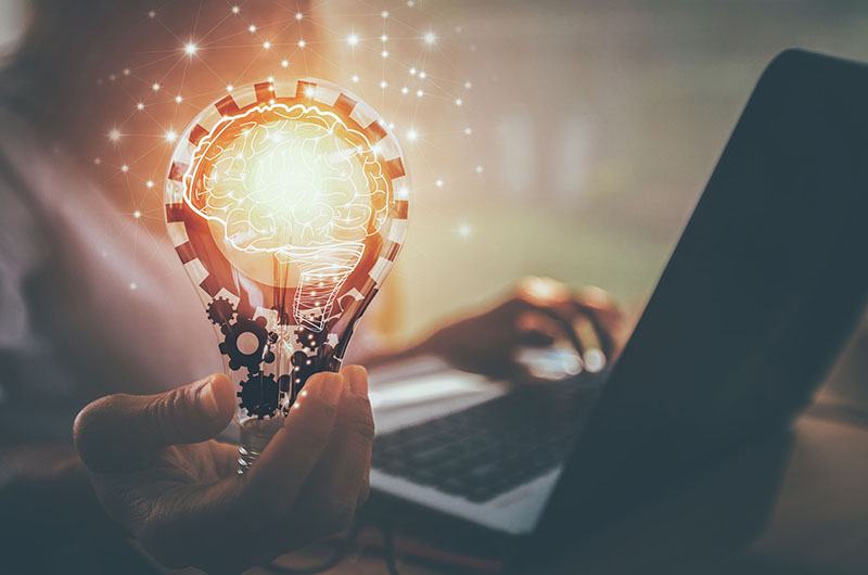 Lighbulb lit near a laptop