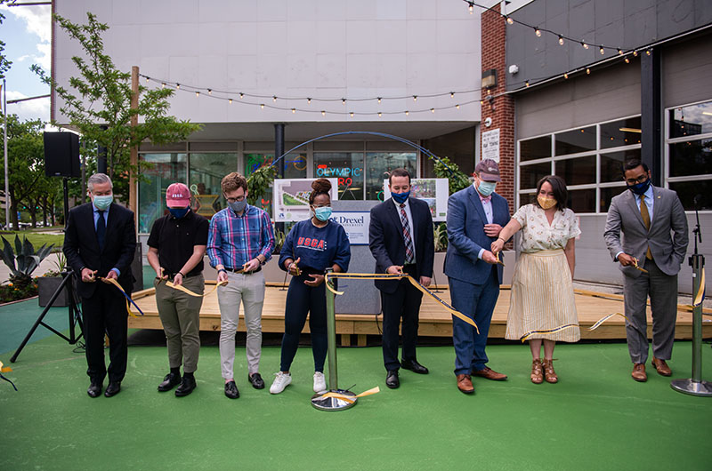 Drexel and Pennsylvania Horticulural Society representatives cut the ribbon at the Gateway Garden on 32nd and Market Streets