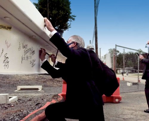 John Fry signing a beam