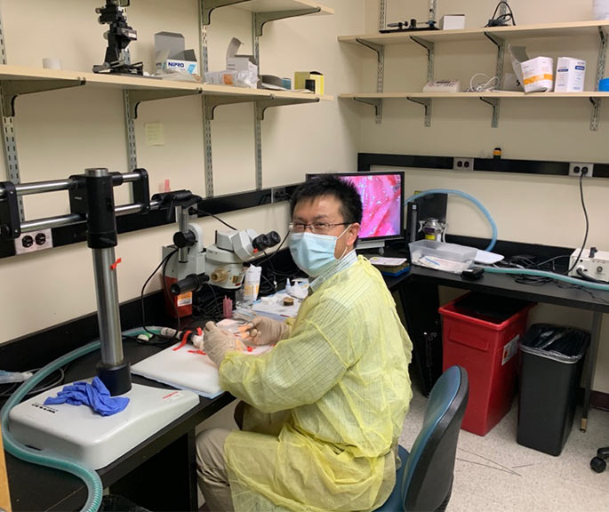 Person in a lab with a mask on