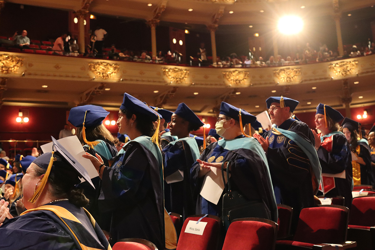 Image of Graduating Students Standing up in the 2026 SoE Commencement Ceremony