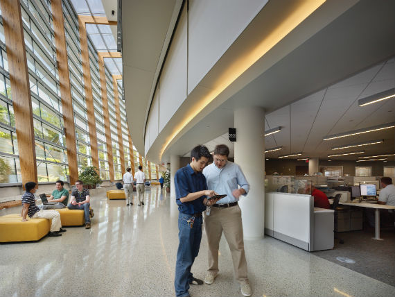 Two employees looking at mobile device in SAP lobby 