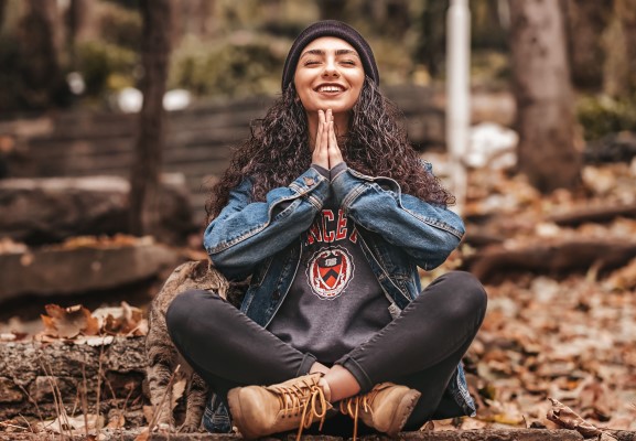 Image of a smiling girl who is meditating
