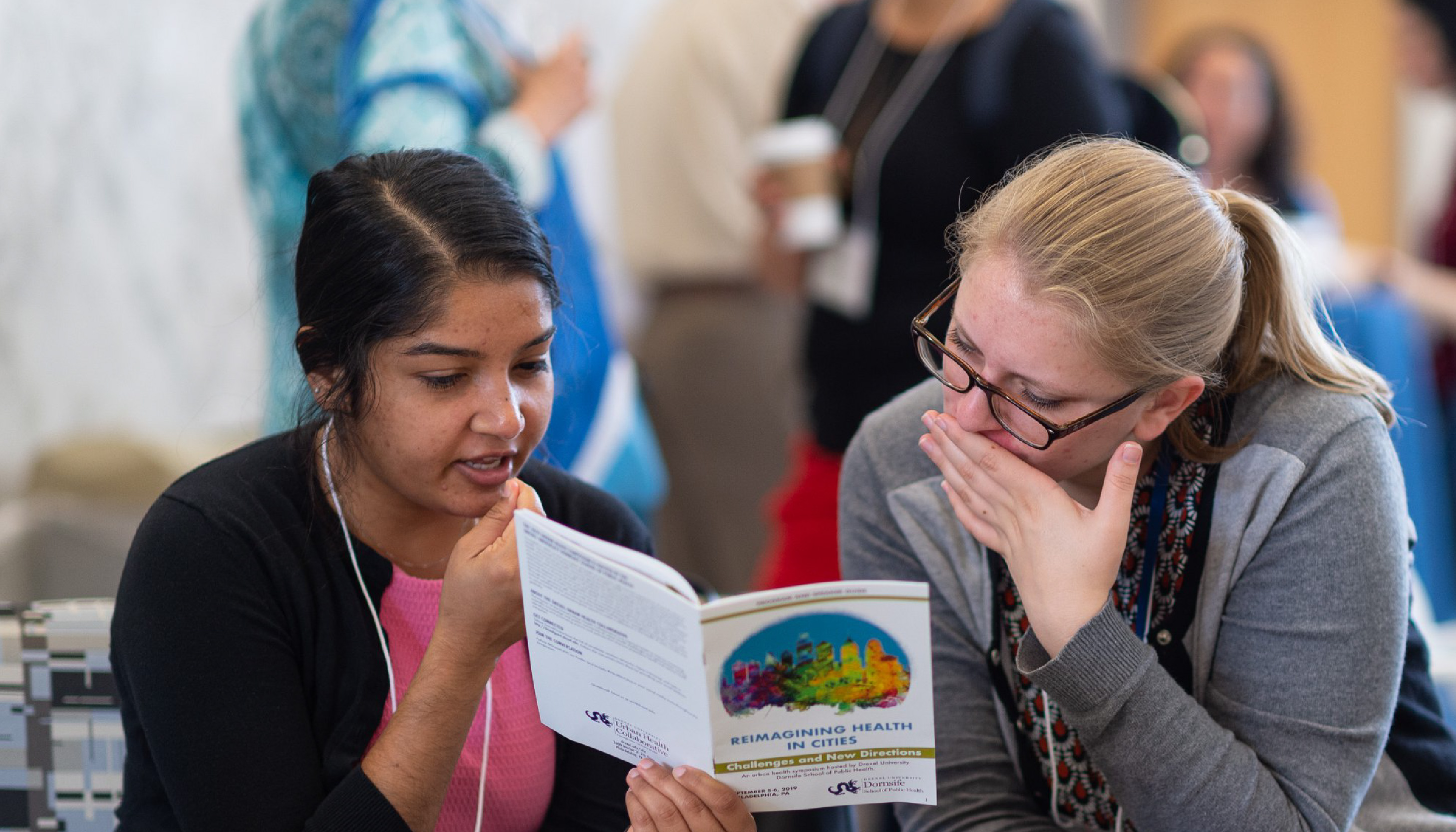 image of two individuals looking at symposium program