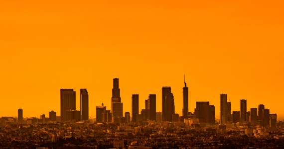 A city skyline against a sky made orange from pollution