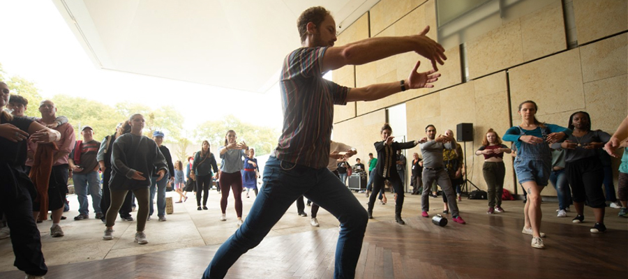 Male performer leading a group of dancers at the Barnes Foundation museum.