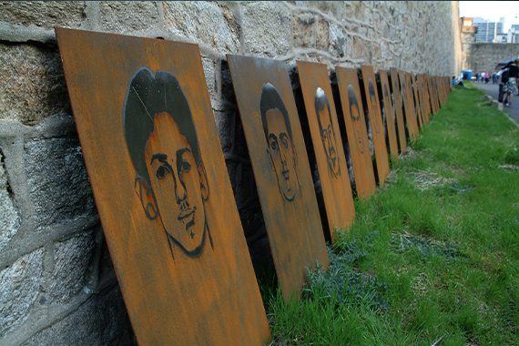 'Portraits of Inmates in the Death Row Population Sentenced as Juveniles' by Nick Cassway, steel plates with sketchings of faces are lined up against the wall of the Eastern State Penitentiary.