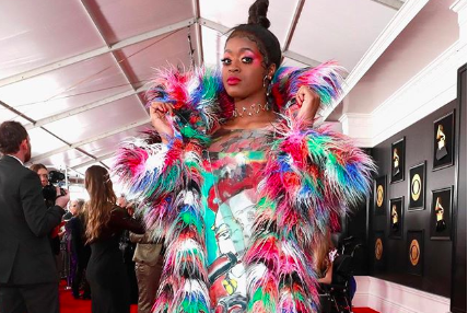Rapper Tierra Whack wearing colorful coat on Grammy red carpet