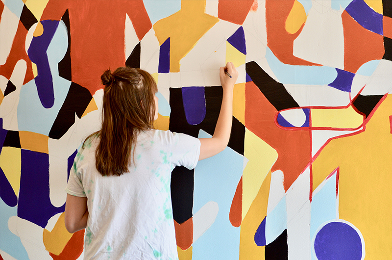 Muralist Laura Coppard paints Saxbys mural