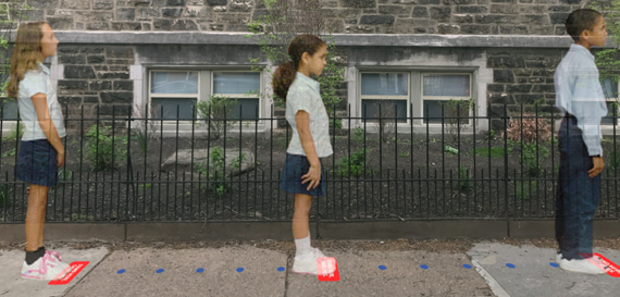 Three young children standing on SAFE stickers