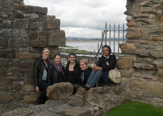 Photograph of 5 students in Edinburgh with water in the background