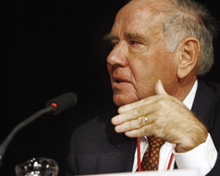 Profile view of Harries given a lecture at a microphone