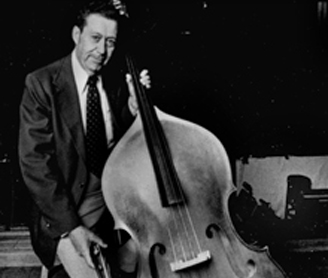 Black and White photograph of Arian holding bass on stage