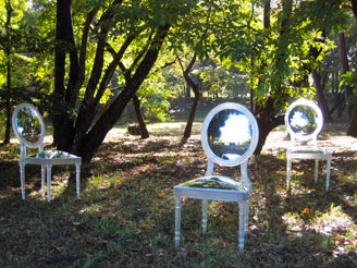 mirrored chairs surrounded by trees