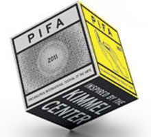 Profile view of Harries given a lecture at a microphone with his arm raised to his chin