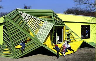 Photograph of an innovative school house and playground