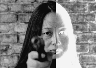 woman holding gun facing towards you