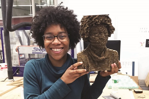 Product Design student holding self portrait sculpture